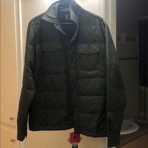 Green down jacket with storage pouch. NWT
